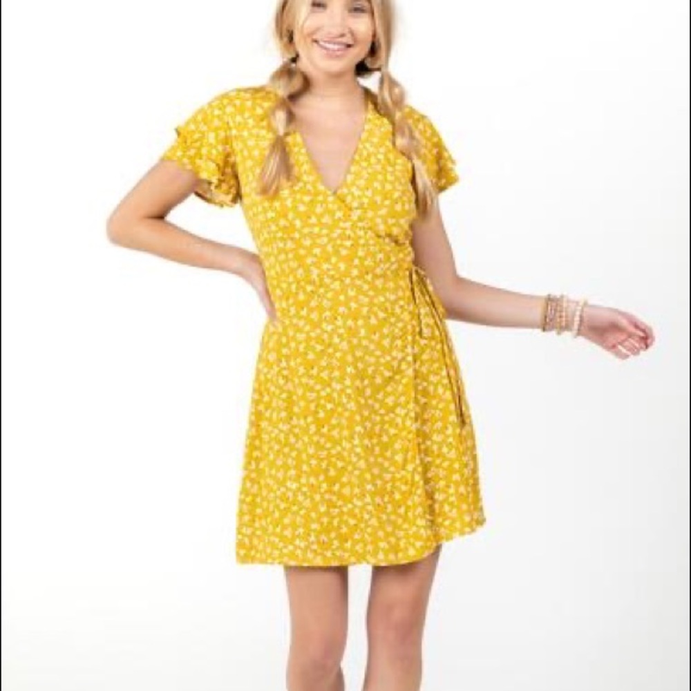 Yellow floral wrap mini dress with tie waist and ruffle cap sleeves